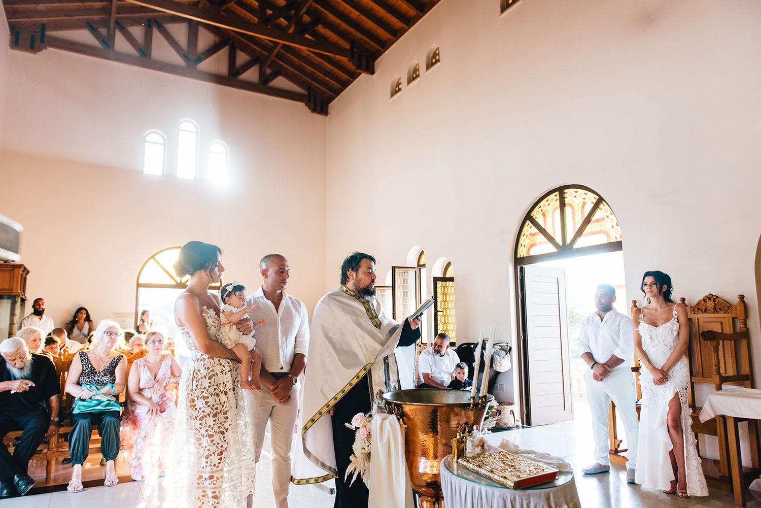 Christening ceremony inside the Chapel of St. Andreas with family and guests, Protaras