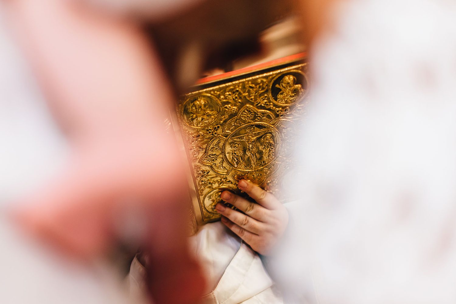 Golden bible held in a hand during the christening, Protaras, Cyprus