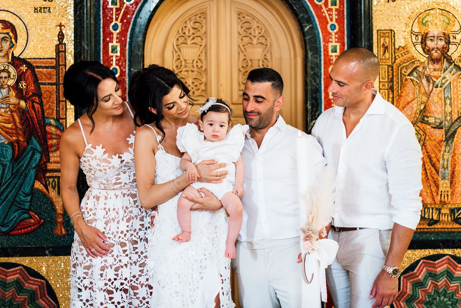 Chloe with her parents and godparents in front of the chapel icons, Protaras