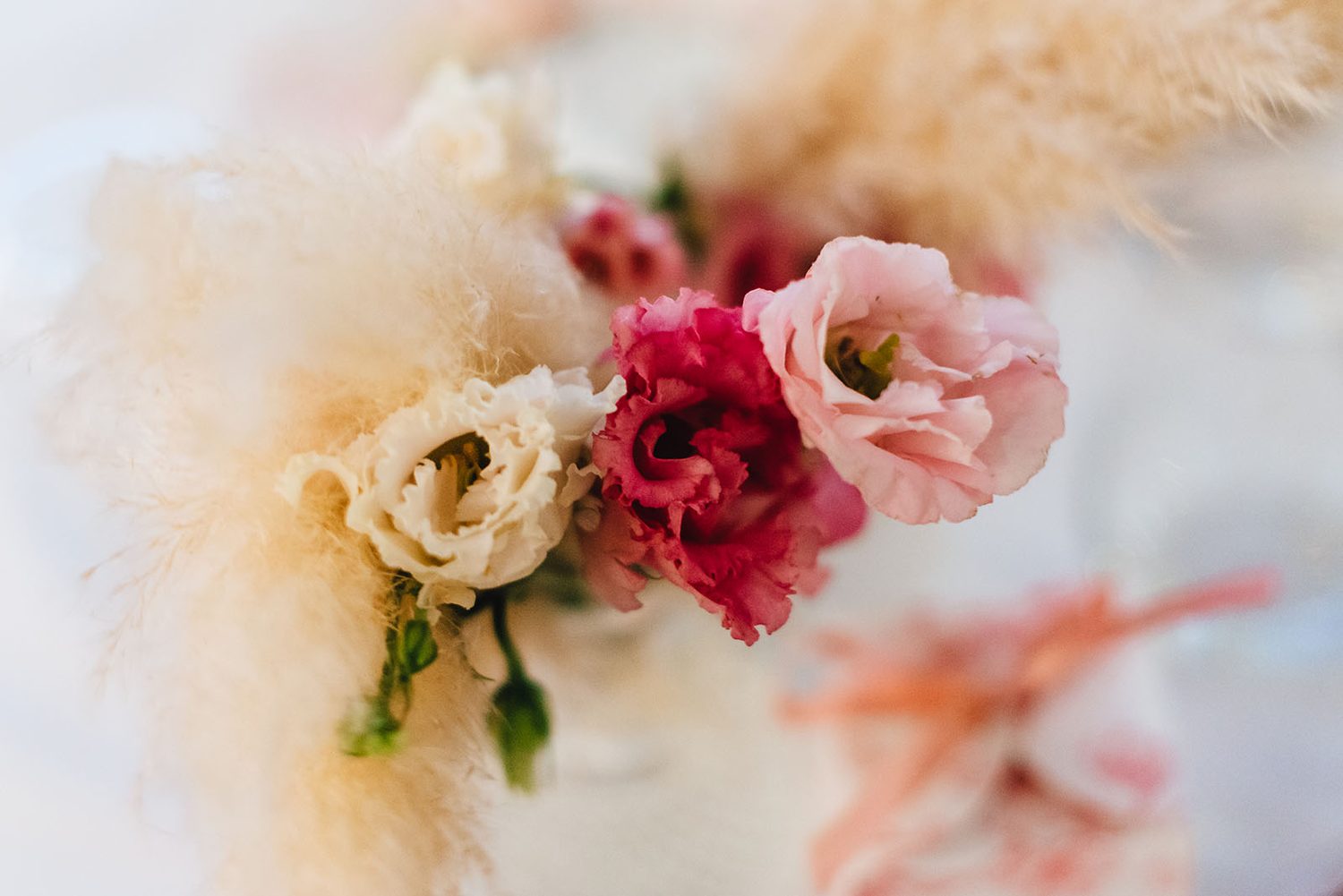 Close-up of roses and pampas grass at a Protaras christening dinner