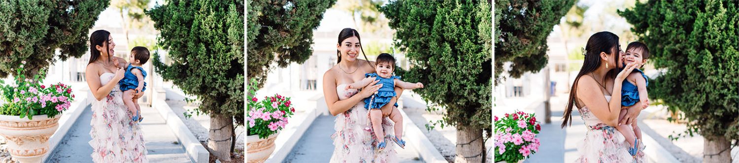 Three-photo collage of the godmother holding and kissing the baby girl on a garden path with cypress trees