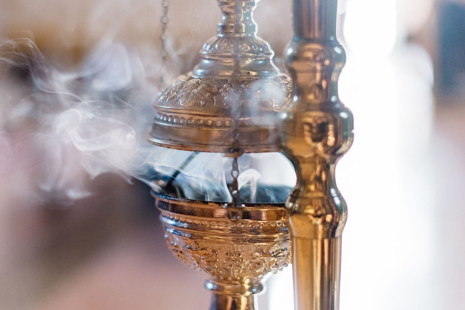 Golden censer releasing smoke inside the church during the christening