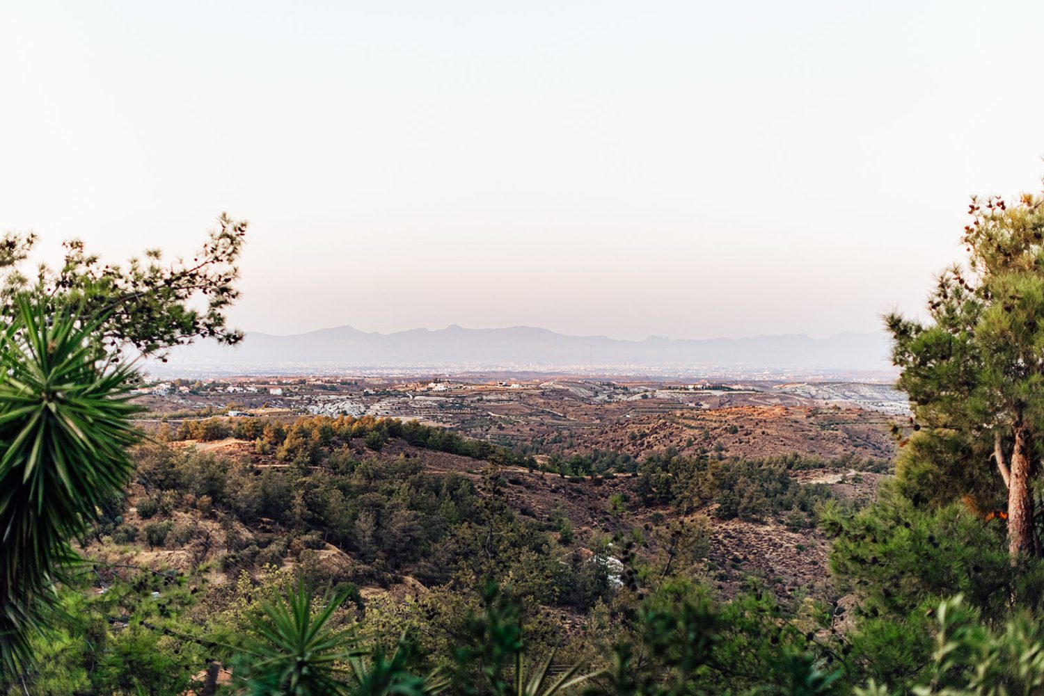 View over hills and trees at sunset from Kampia restaurant, looking toward the mountains